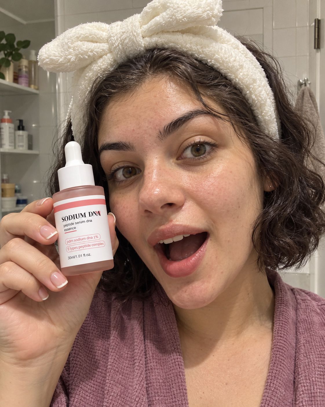 Woman with a headband holding Salmora serum